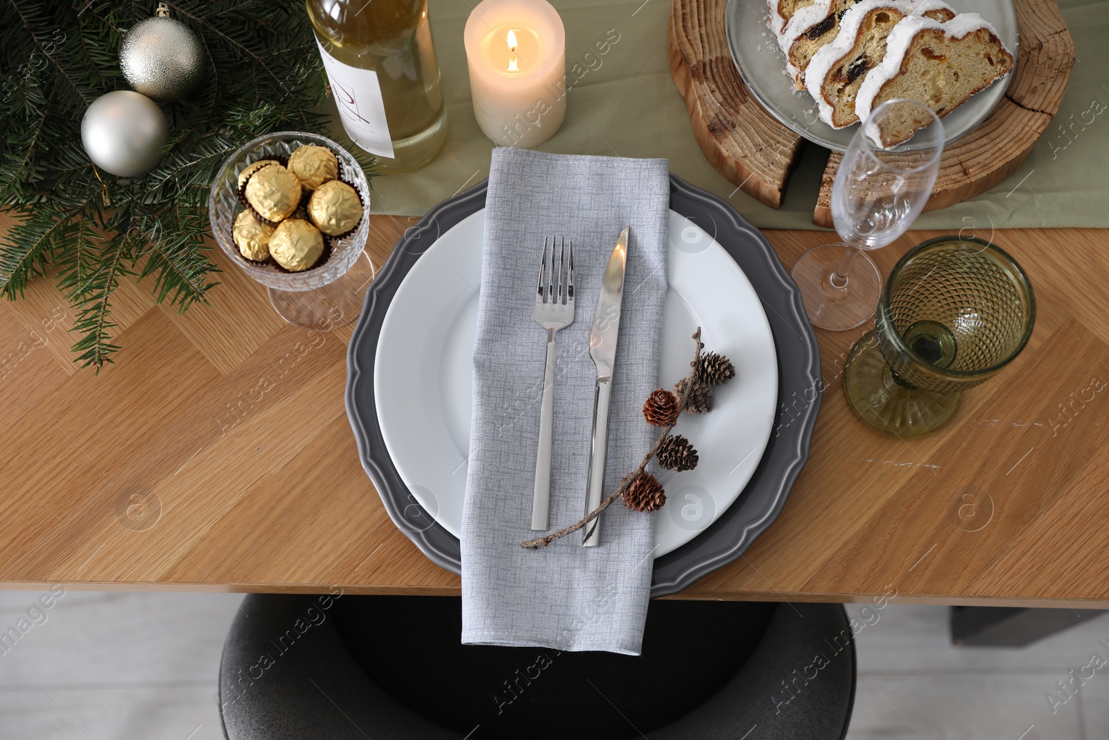 Photo of Christmas table setting with festive decor and dishware, top view