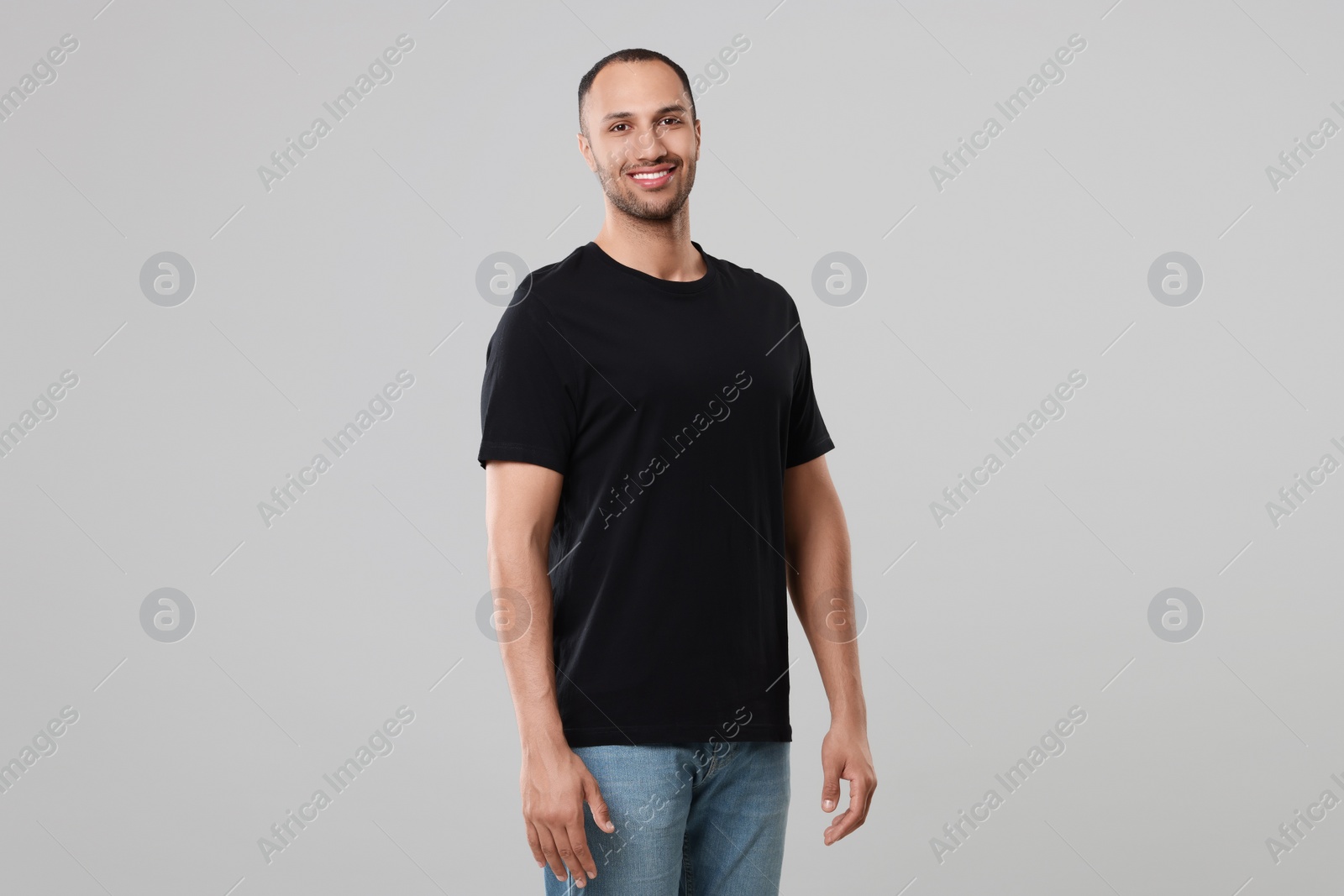 Photo of Man wearing black t-shirt on gray background