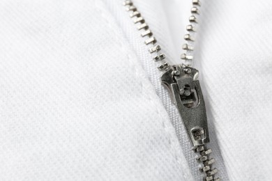 Photo of White jacket with zipper as background, closeup view. Space for text