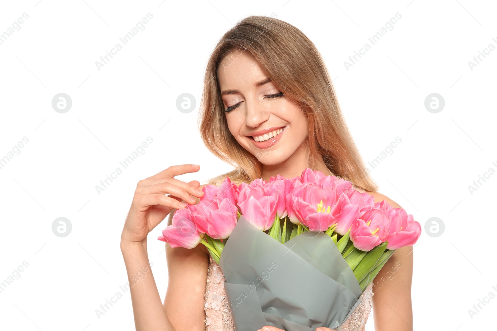 Photo of Portrait of smiling young girl with beautiful tulips on white background. International Women's Day