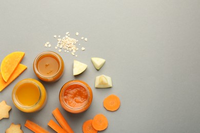 Flat lay composition with healthy baby food on grey background. Space for text