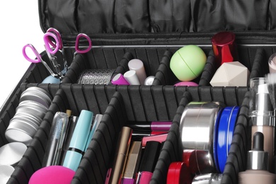 Photo of Stylish case with makeup products and beauty accessories, closeup