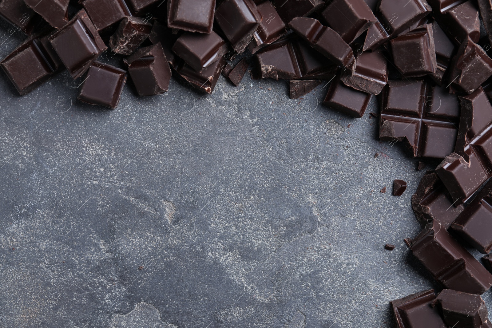 Photo of Delicious dark chocolate on light grey table, flat lay. Space for text