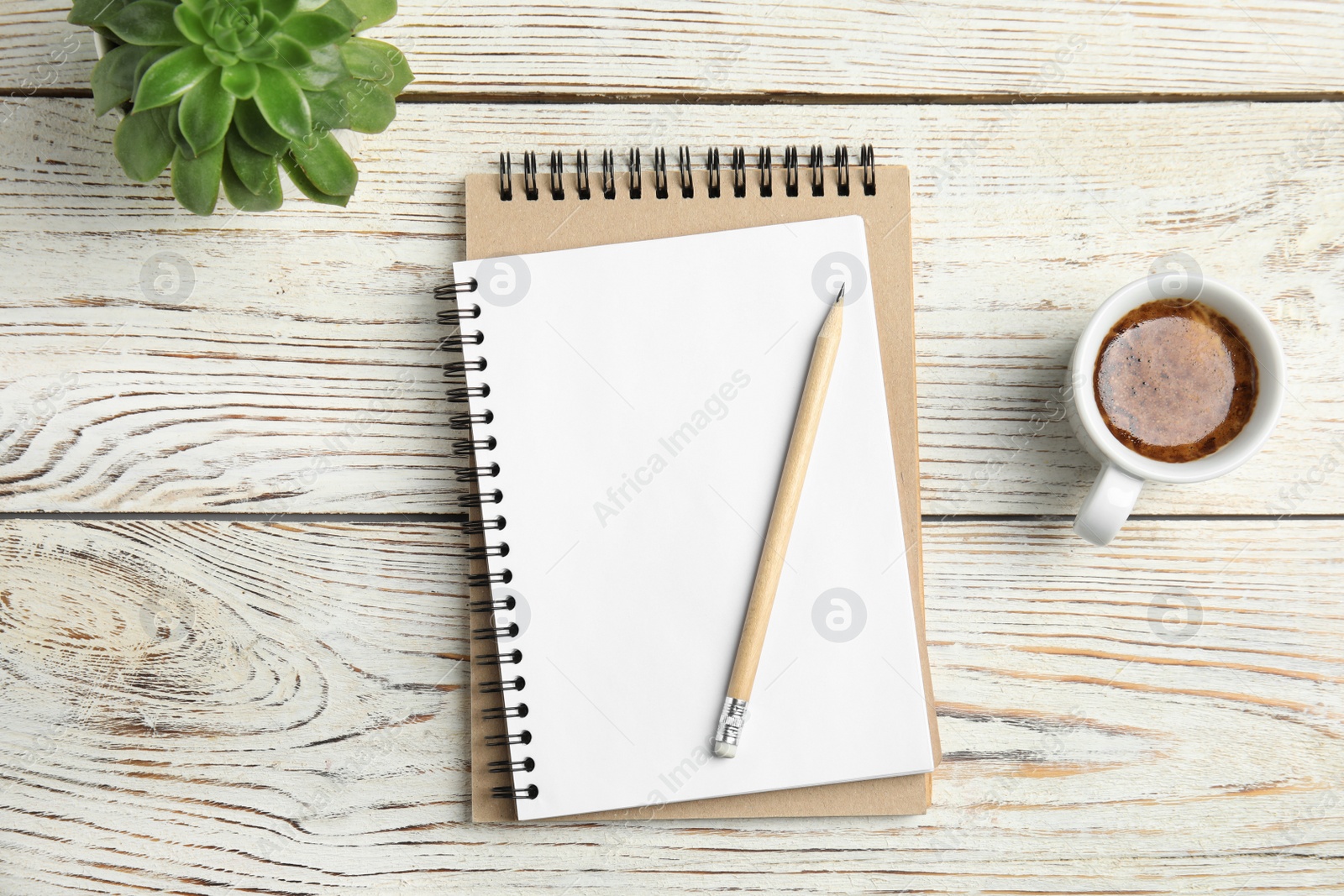 Photo of Flat lay composition with notebooks and coffee on wooden background