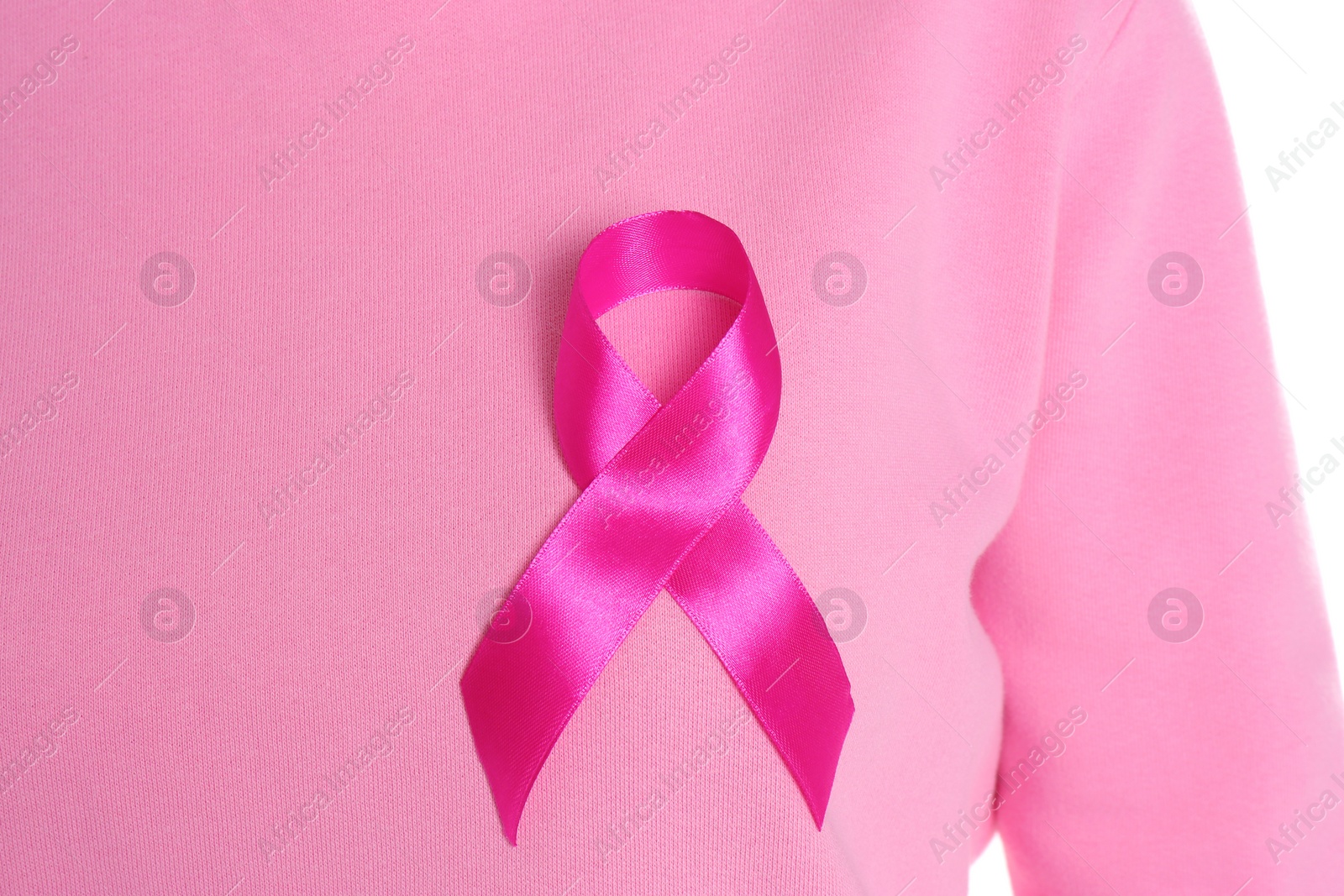 Photo of Woman with pink ribbon on white background, closeup. Breast cancer awareness