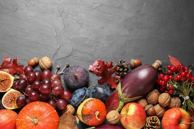 Photo of Flat lay composition with autumn vegetables and fruits on grey background, space for text. Happy Thanksgiving day