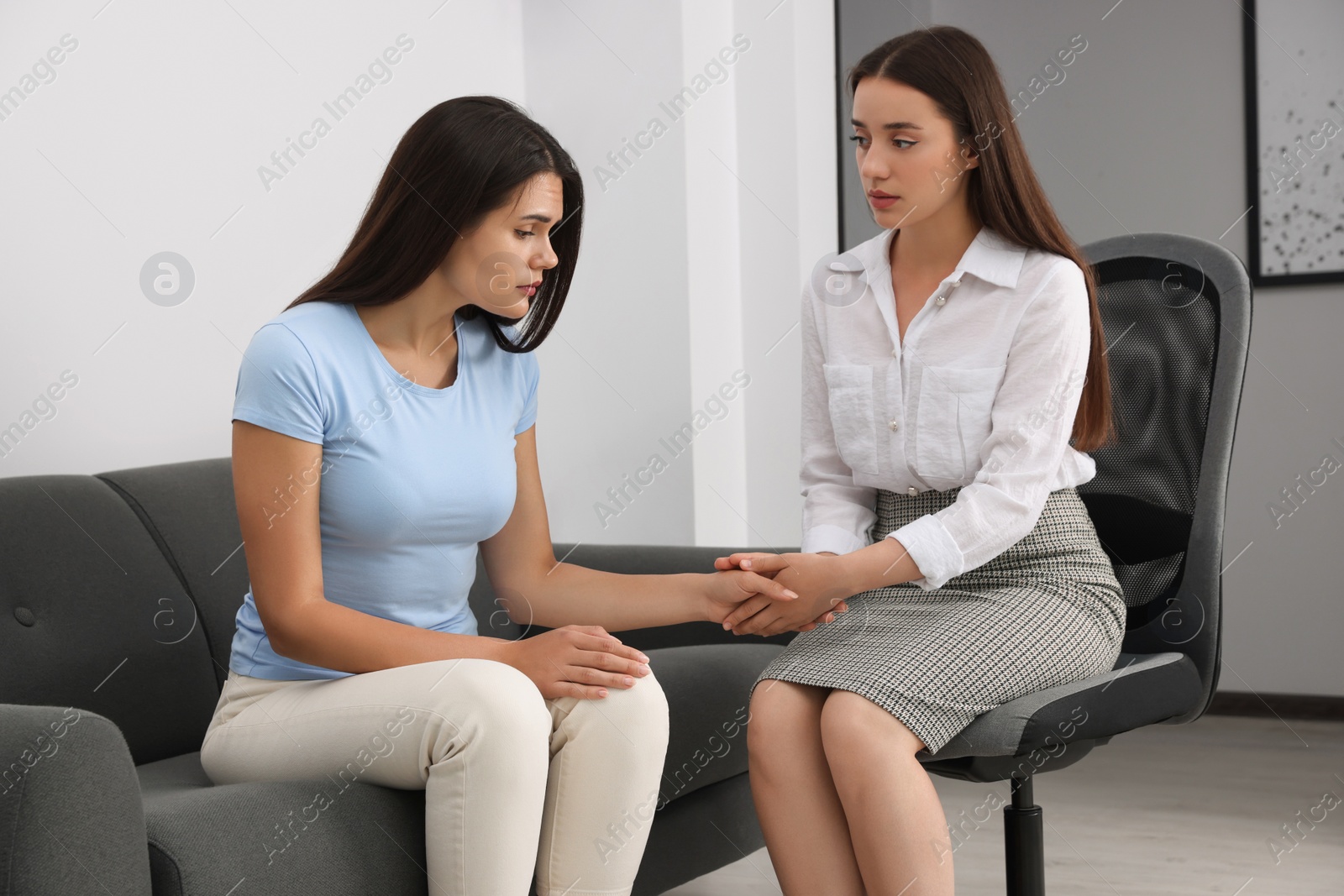 Photo of Professional psychologist working with young woman in office