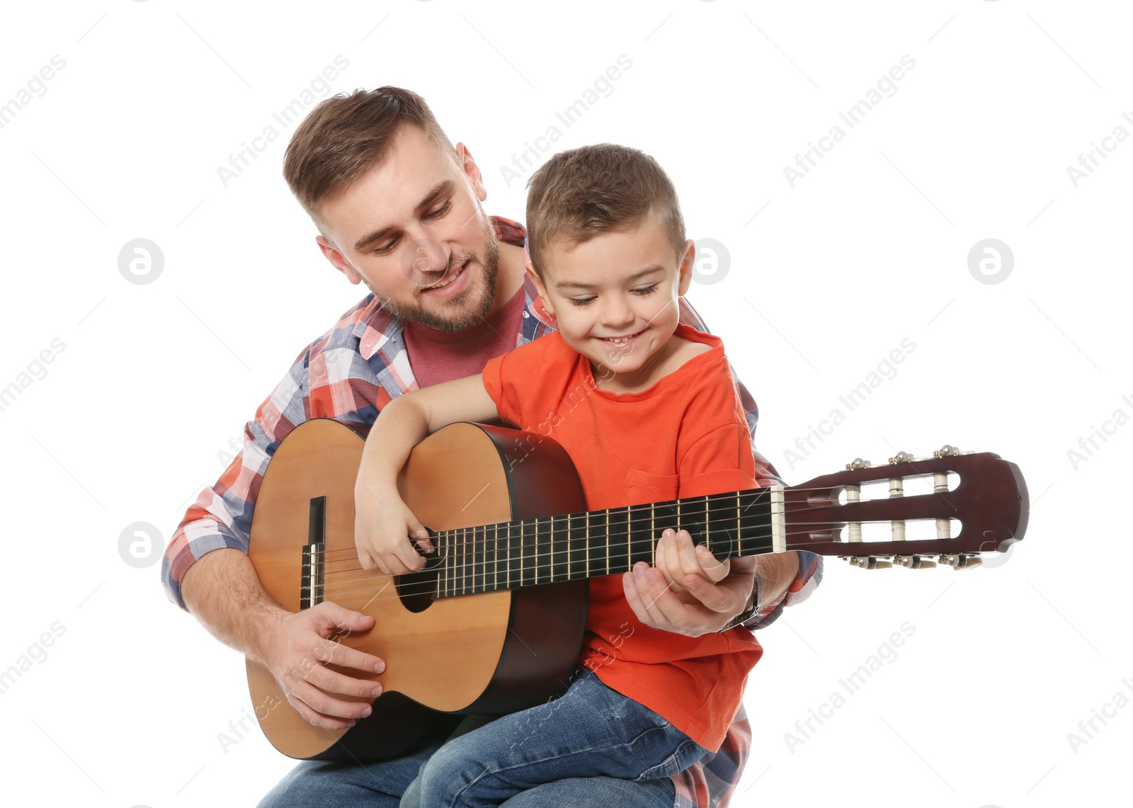 Photo of Father teaching his little son to play guitar on white background