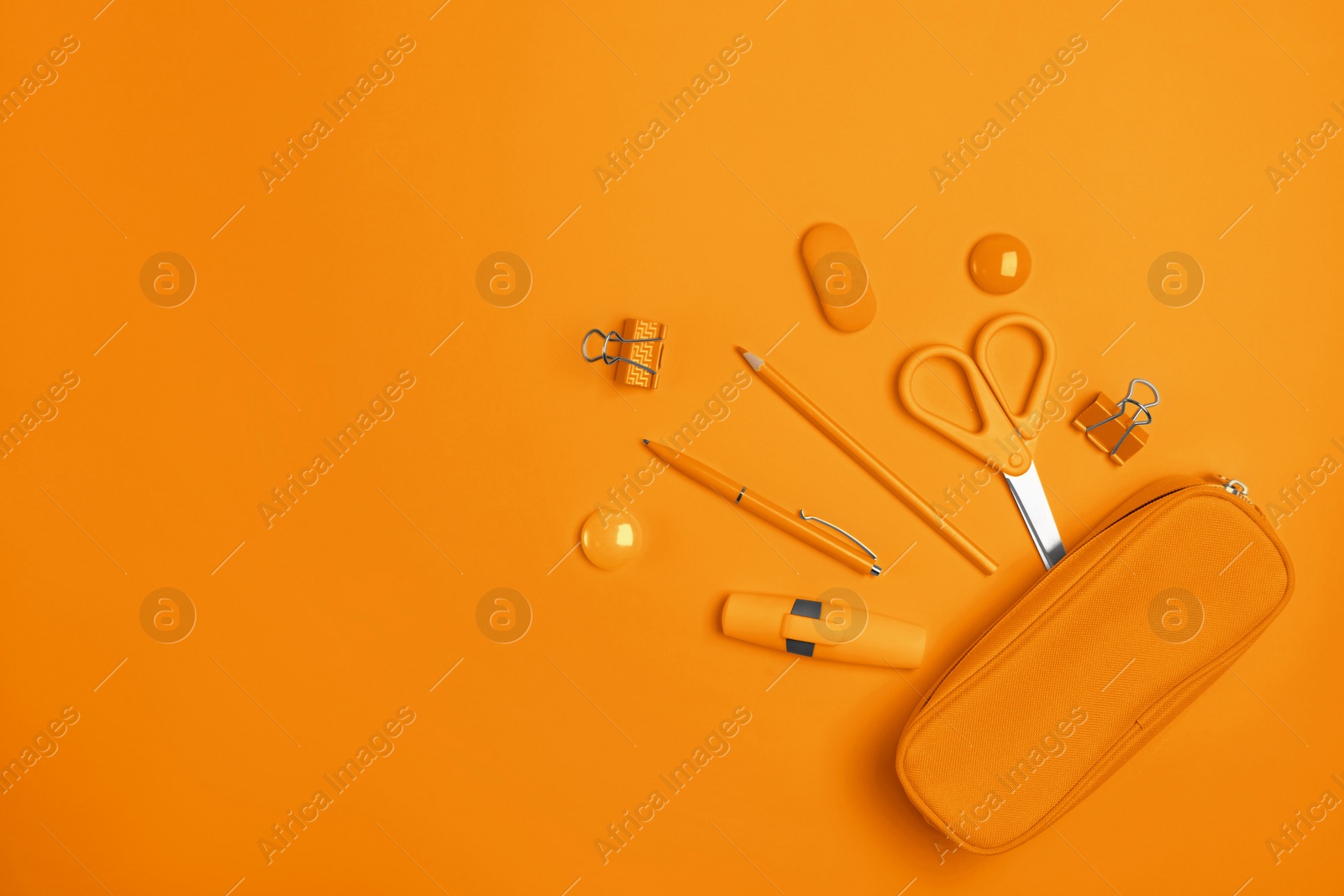 Image of Flat lay composition with pencil box and stationery on orange background. Space for text