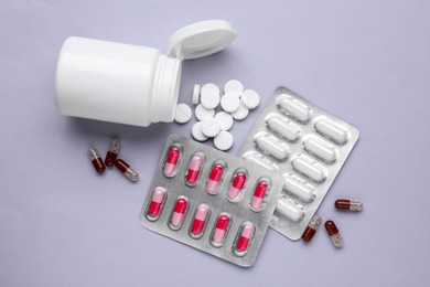 Photo of Different antidepressants and medical bottle on grey background, flat lay