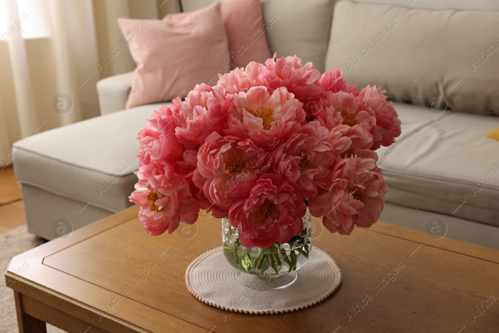 Photo of Beautiful pink peonies in vase on table at home. Interior design