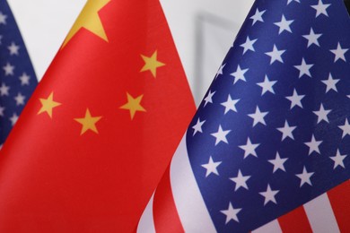 Photo of USA and China flags, closeup. International relations