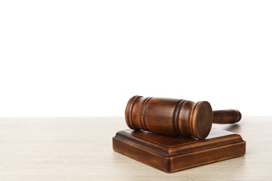 Photo of Wooden gavel on light table against white background. Space for text