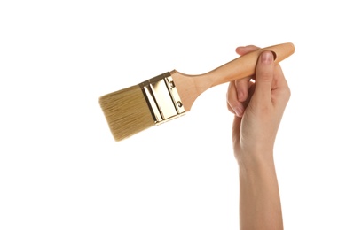 Photo of Woman holding paint brush on white background, closeup