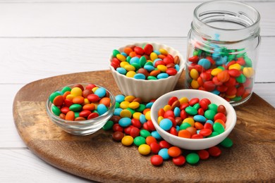 Photo of Tasty colorful candies on white wooden table