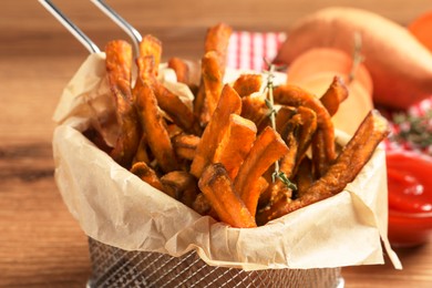 Sweet potato fries on wooden table, closeup