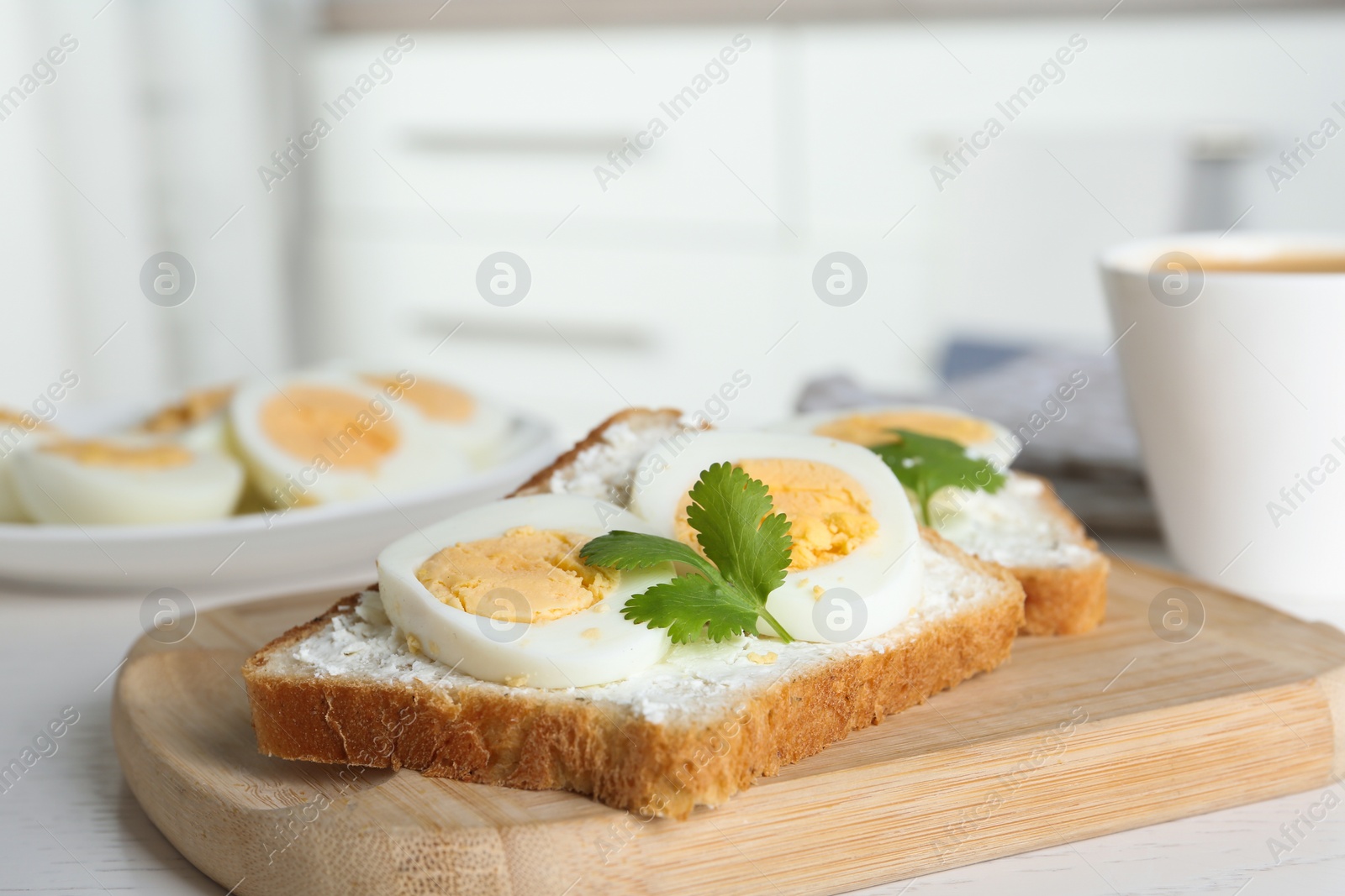 Photo of Tasty sandwiches with boiled eggs on wooden board, closeup