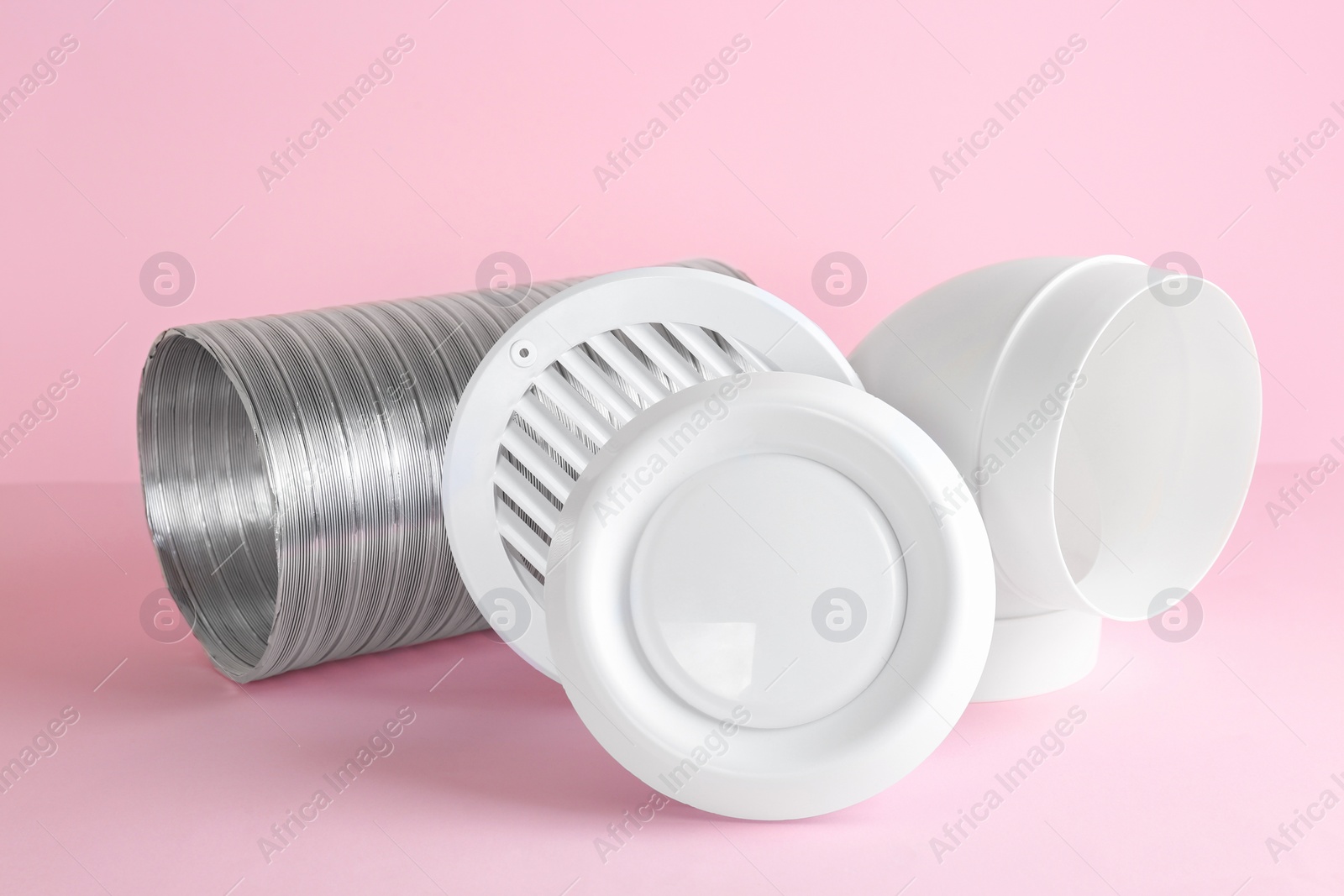 Photo of Parts of home ventilation system on pink background