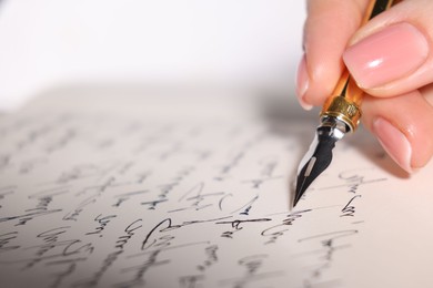 Photo of Woman writing letter with fountain pen, closeup