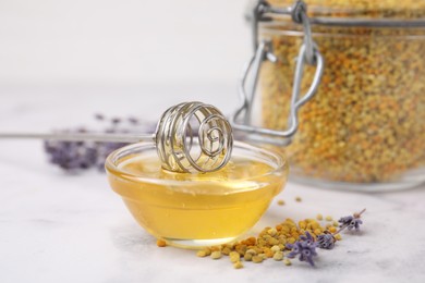 Photo of Fresh honey in bowl, dipper, bee pollen granules and lavender on light table, closeup