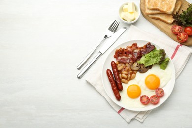 Delicious breakfast with sunny side up eggs served on white table, flat lay. Space for text