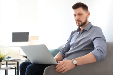 Photo of Male lawyer working with laptop in office