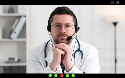 Image of Online medical consultation. Doctor with headset working via video chat application