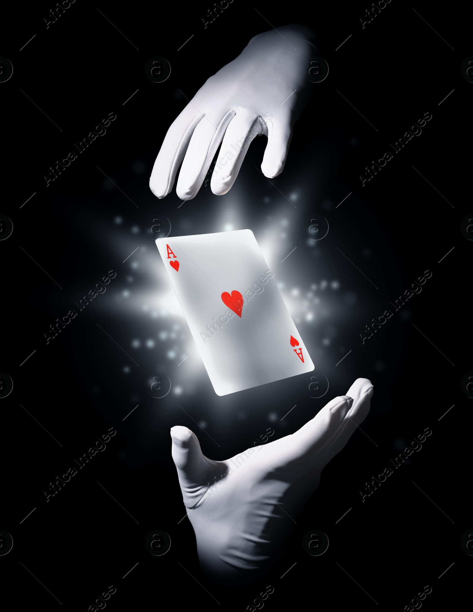 Image of Magician performing card trick on black background, closeup