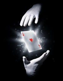 Magician performing card trick on black background, closeup