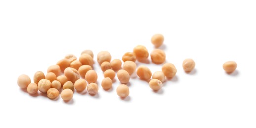 Many whole mustard seeds on white background