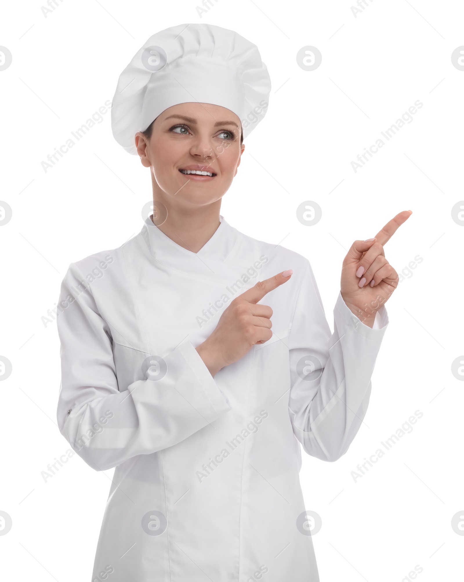 Photo of Happy woman chef in uniform pointing at something on white background