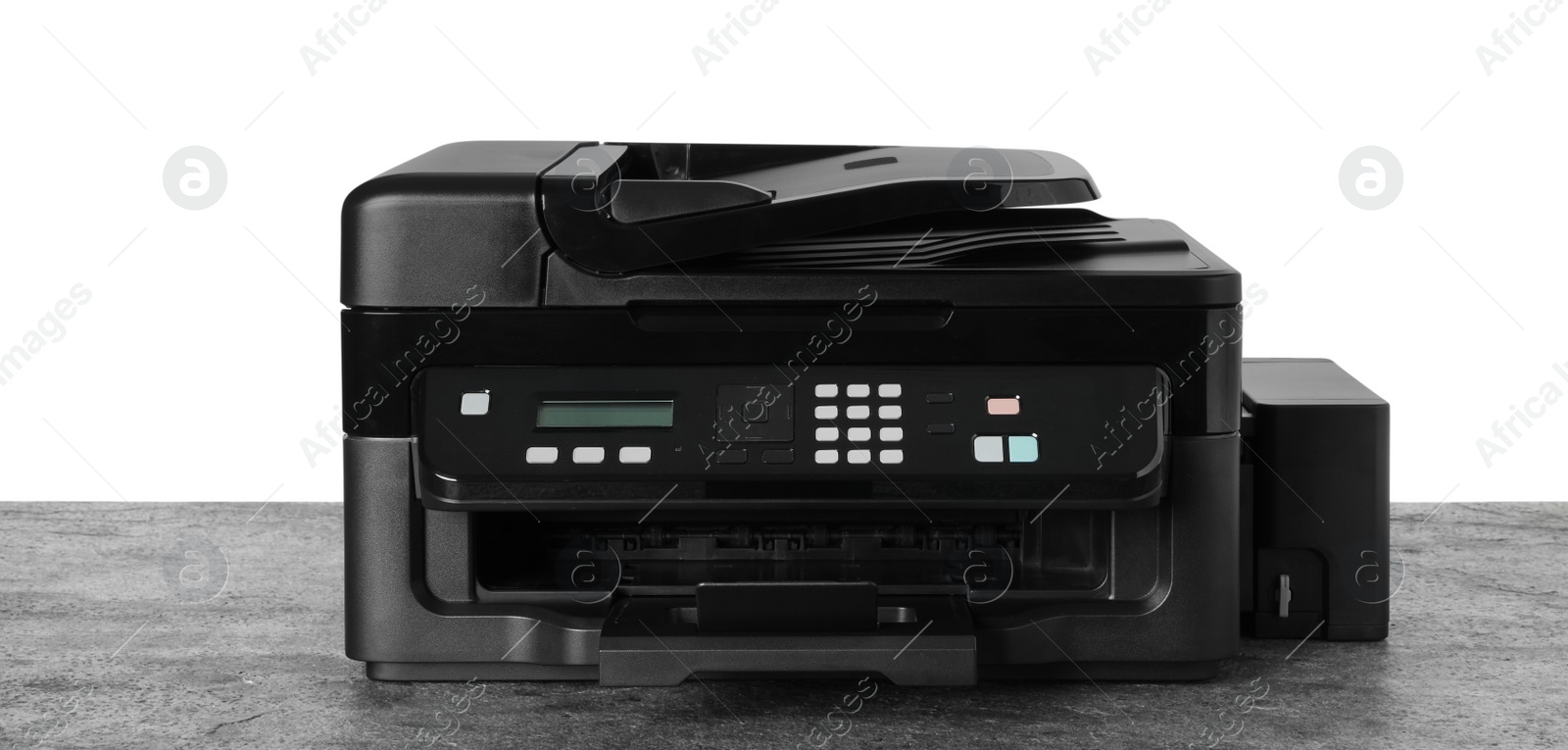 Photo of New modern multifunction printer on grey table