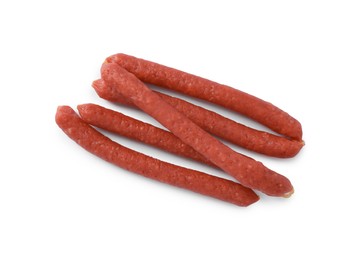 Photo of Thin dry smoked sausages isolated on white, top view