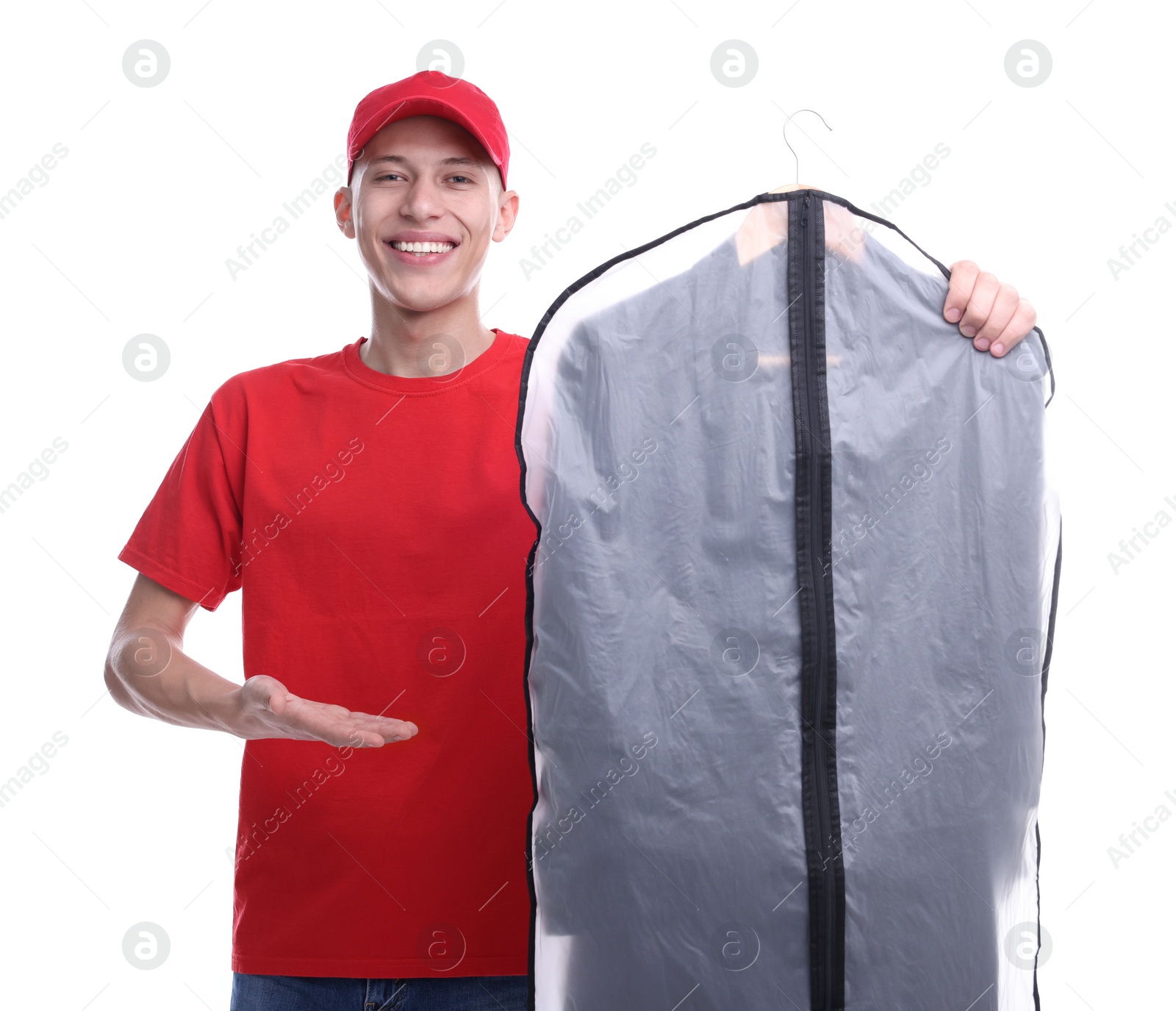 Photo of Dry-cleaning delivery. Happy courier holding garment cover with clothes on white background