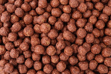 Photo of Sweet crispy chocolate corn balls as background, top view