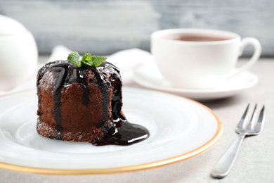 Delicious warm chocolate lava cake on grey table, closeup