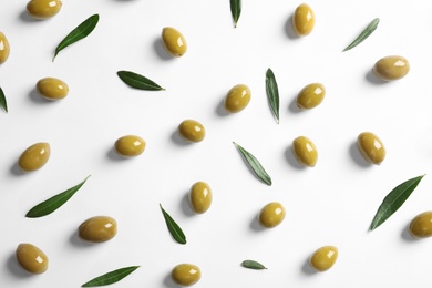 Flat lay composition with fresh olives covered with oil on white background