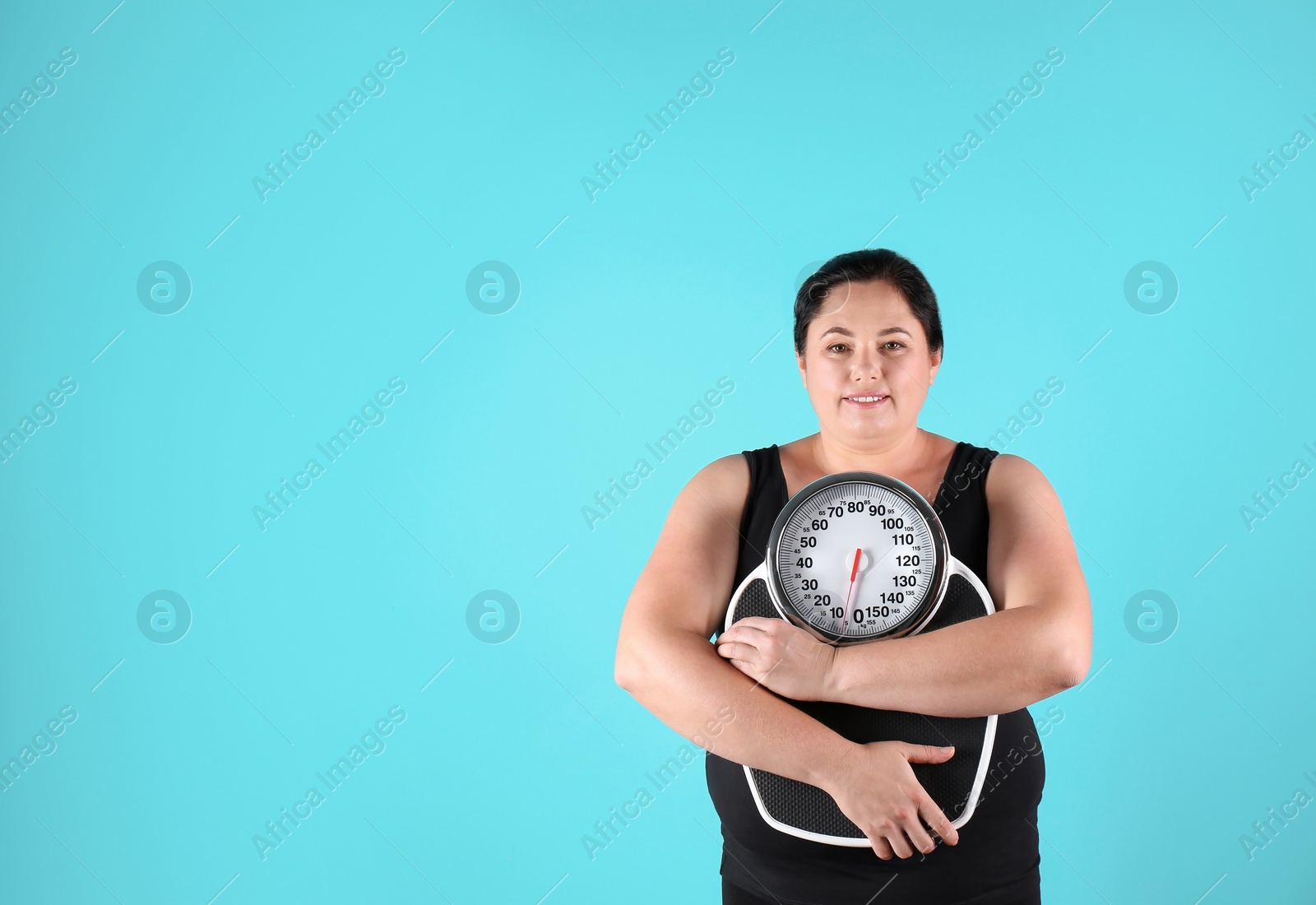 Photo of Overweight woman in sportswear with scales on color background