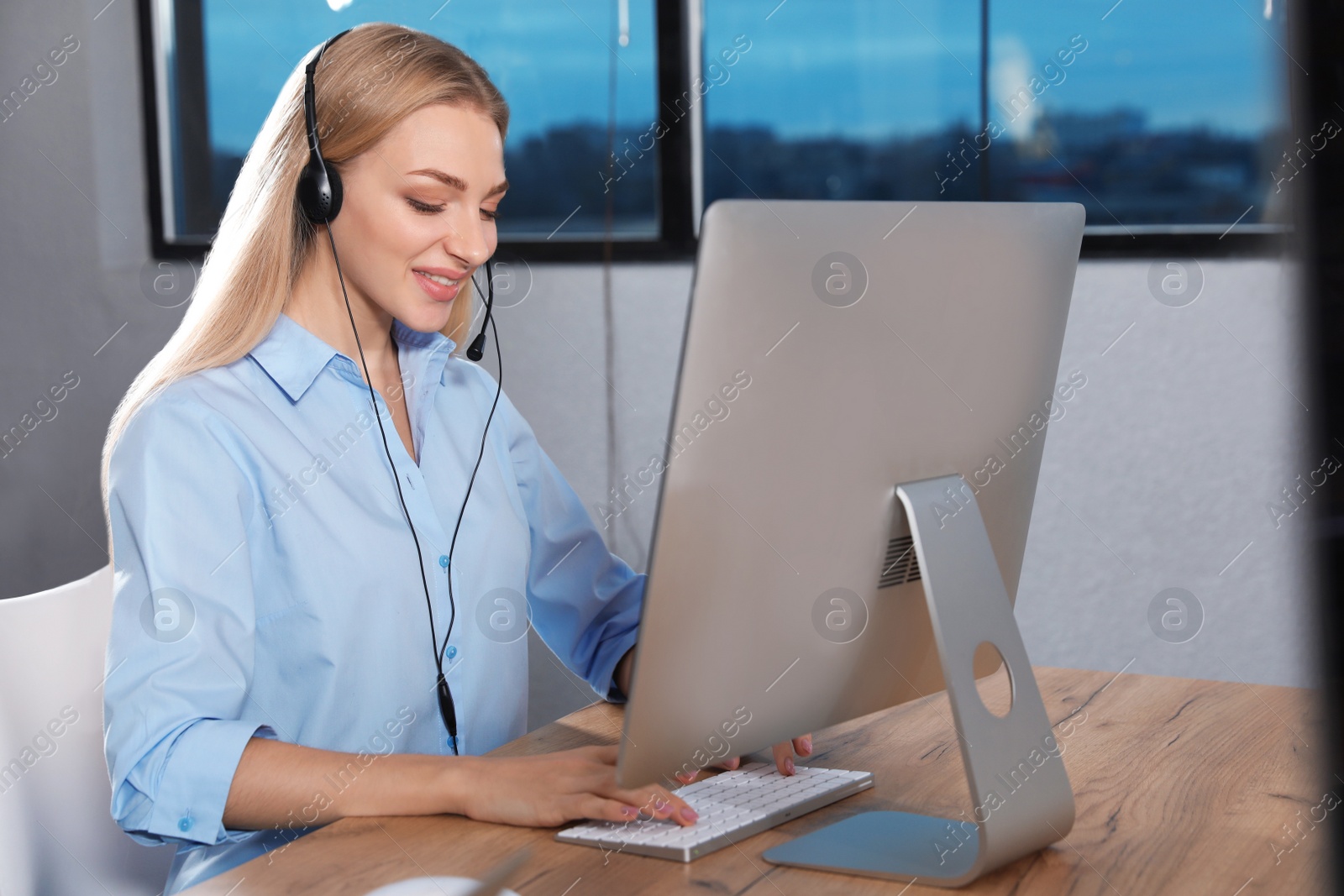 Photo of Technical support operator with headset in modern office