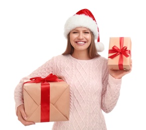 Photo of Happy young woman in Santa hat with Christmas gifts on white background