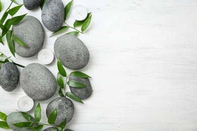 Photo of Spa stones and leaves on wooden background