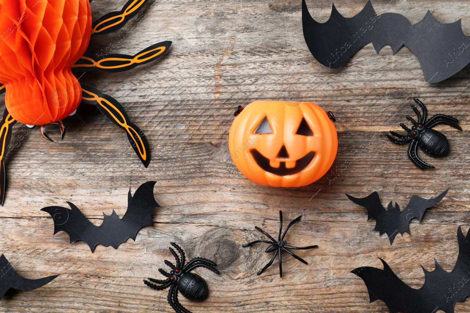 Photo of Halloween decor elements on wooden background, flat lay