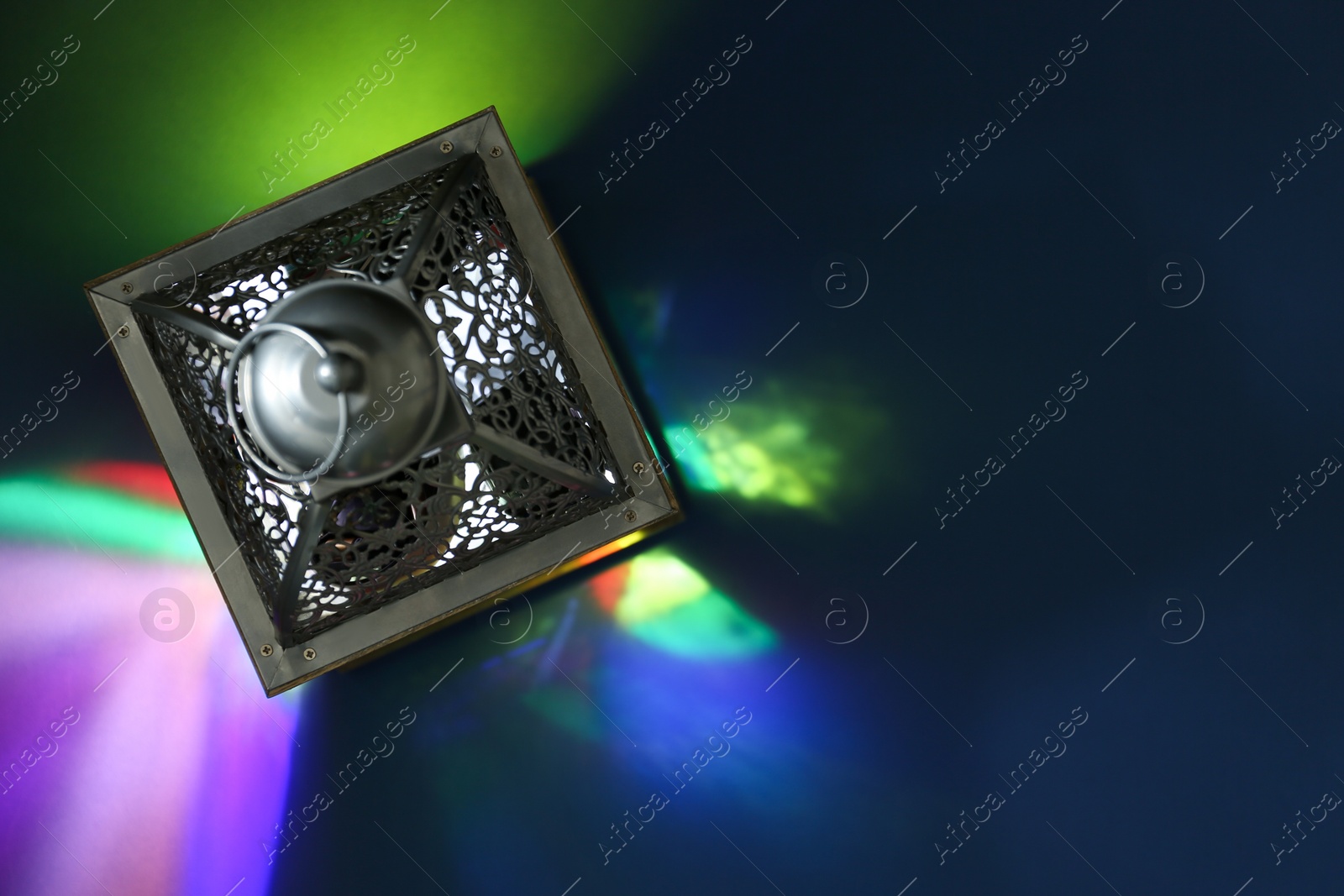 Photo of Decorative Arabic lantern on color background, top view. Space for text