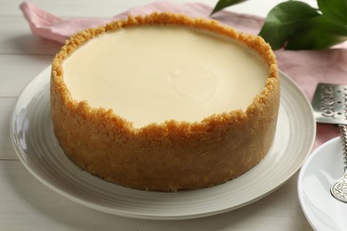 Tasty vegan tofu cheesecake on white table