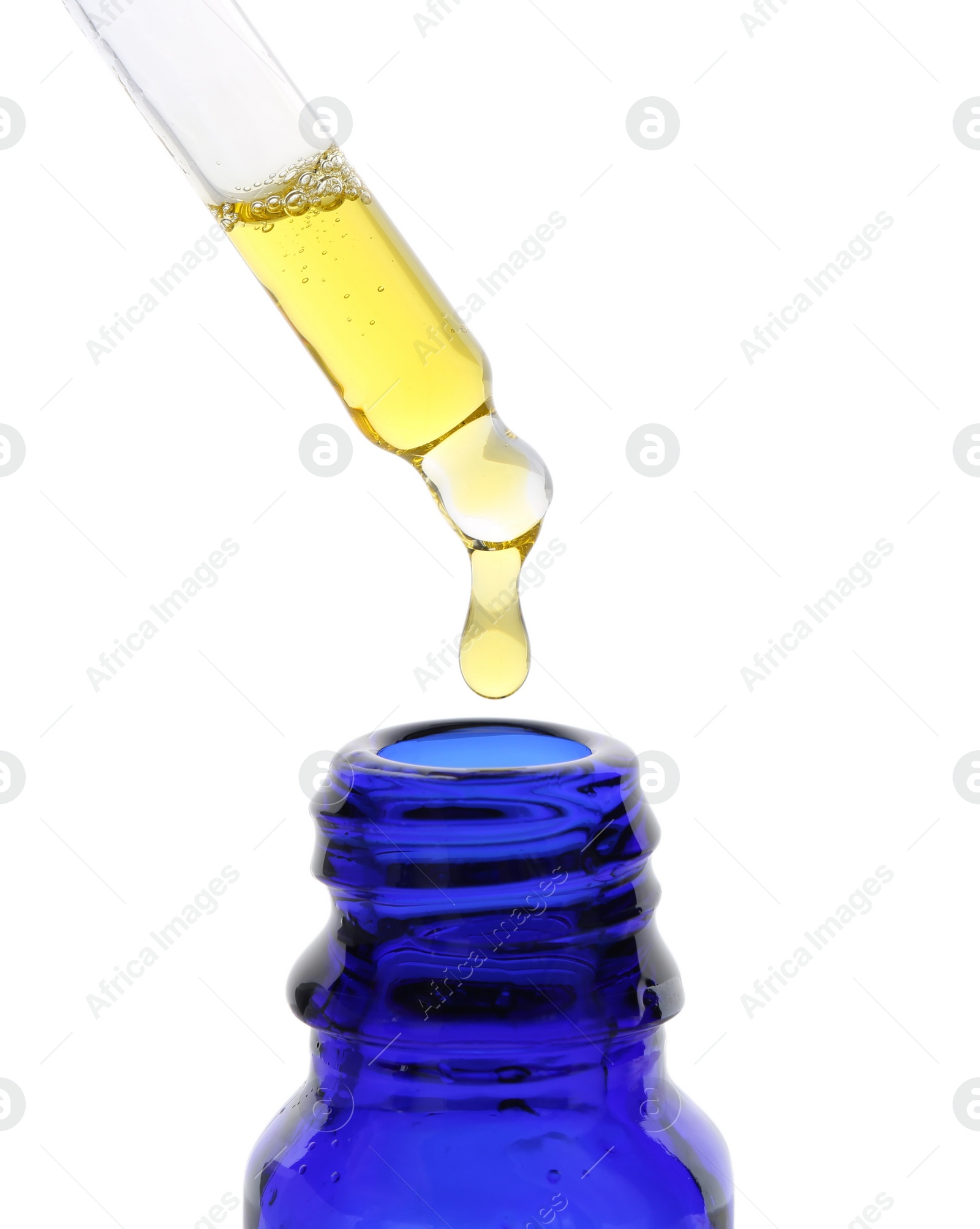 Photo of Dripping tincture from pipette into bottle isolated on white