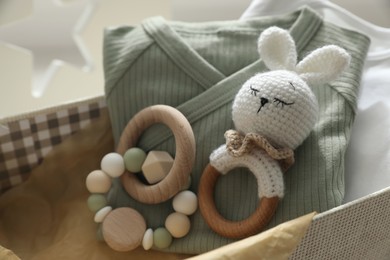 Photo of Box with baby clothes and toys, closeup