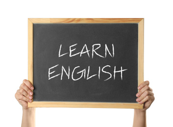 Woman holding blackboard with text Learn English on white background, closeup