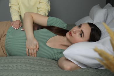 Photo of Doula taking care of pregnant woman indoors. Preparation for child birth