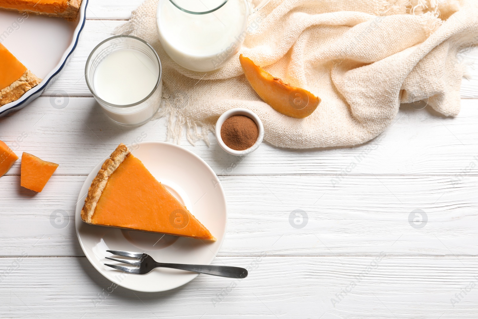 Photo of Flat lay composition with piece of fresh delicious homemade pumpkin pie on wooden background