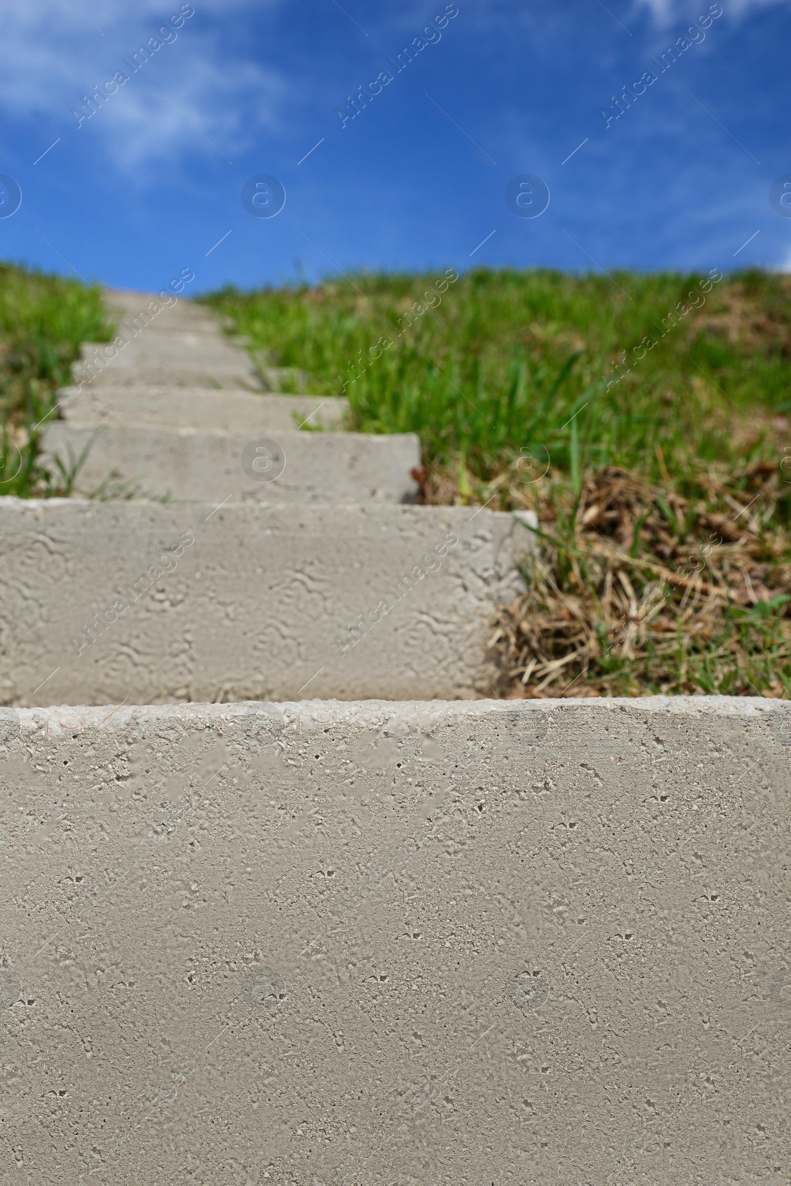 Photo of Outdoor concrete staircase up to hill, low angle view